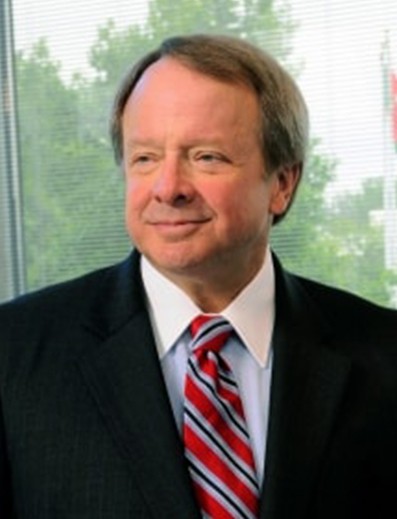 Male employee smiles for camera